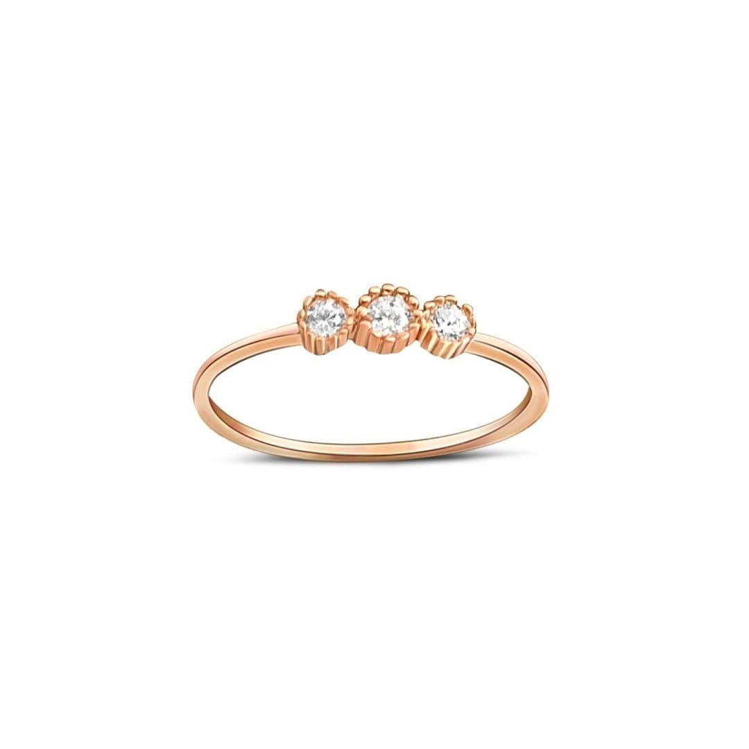 narrow rose gold ring with three cubic zirconia stones