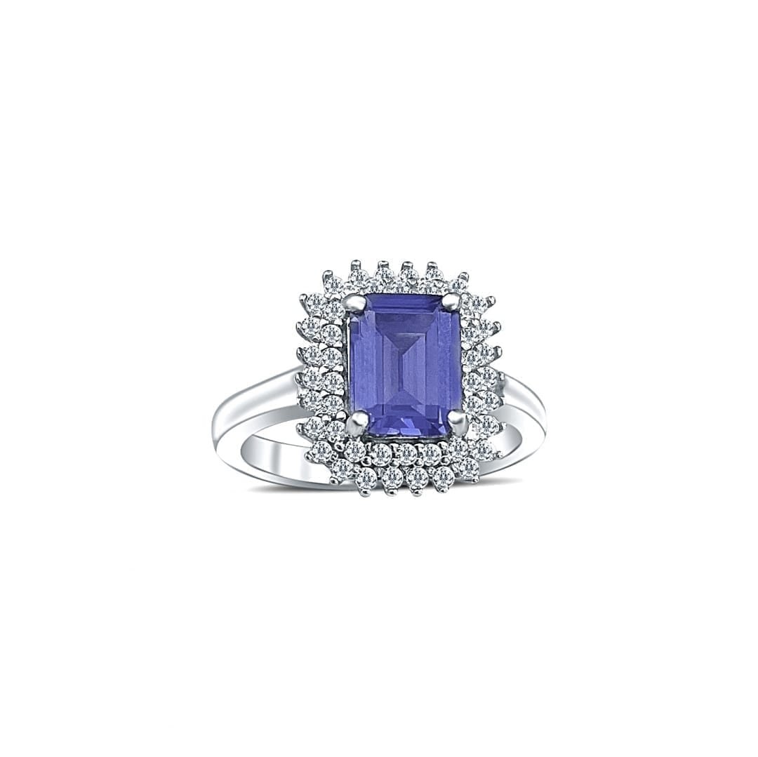 Sterling silver ring with large tanzanite as main stone and multiple cubic zirconia stones around it. The main stone is of emerald cut shape.