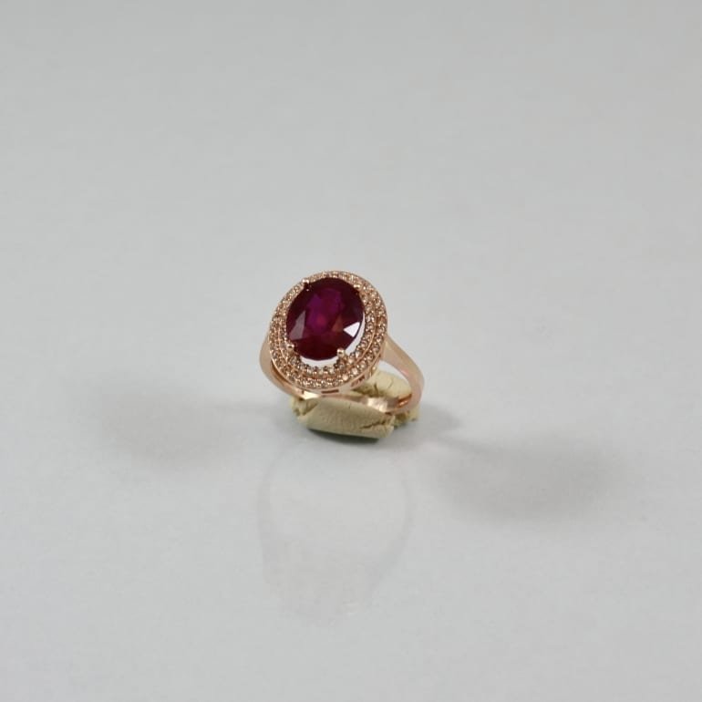 Rose gold ring with oval ruby and cubic zirconia