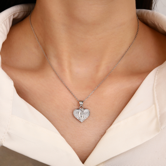 Sterling silver pendant with cubic zirconia stones in a shape of heart with initial G