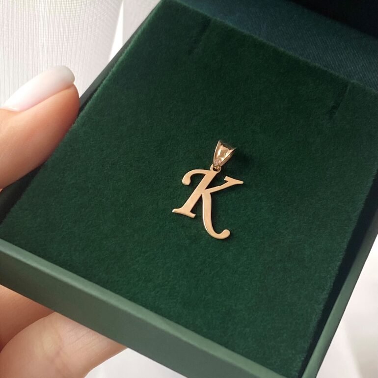 A 14ct rose gold pendant in a shape of initial K