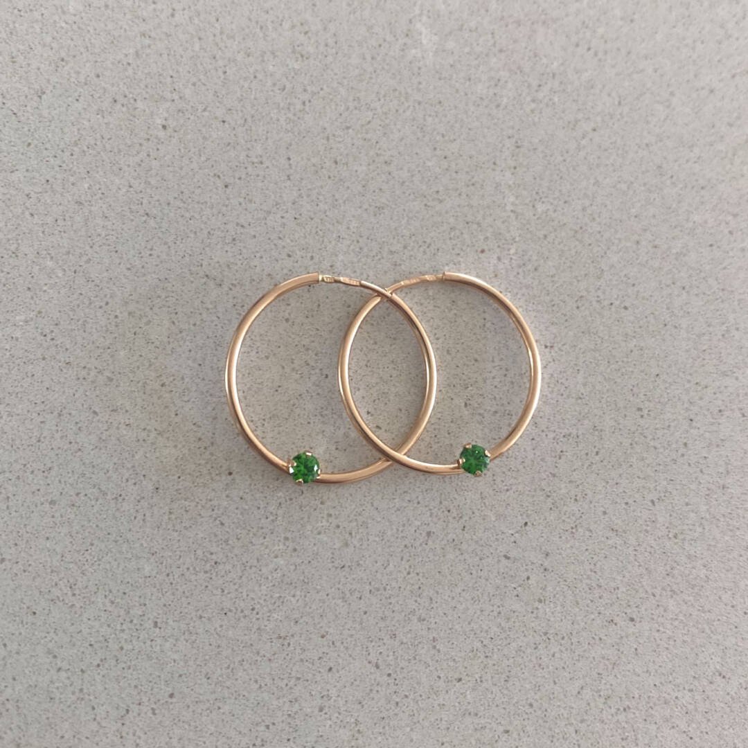 rose gold hoop earrings with green cubic zirconia