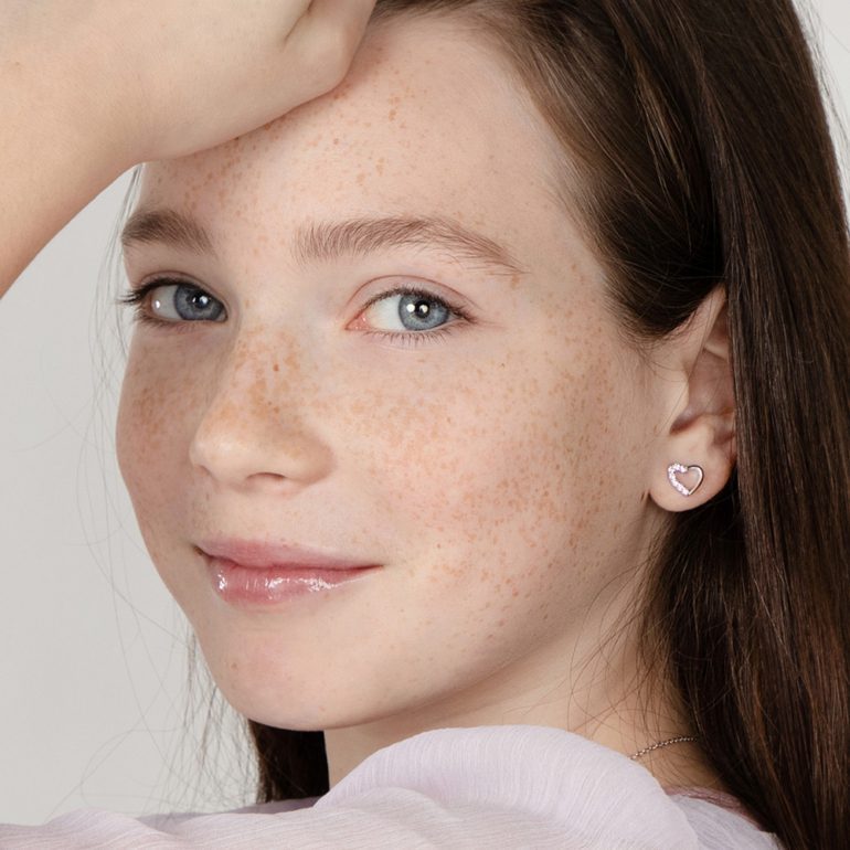 A pair of sterling silver stud earrings with pink cubic zirconia - hearts