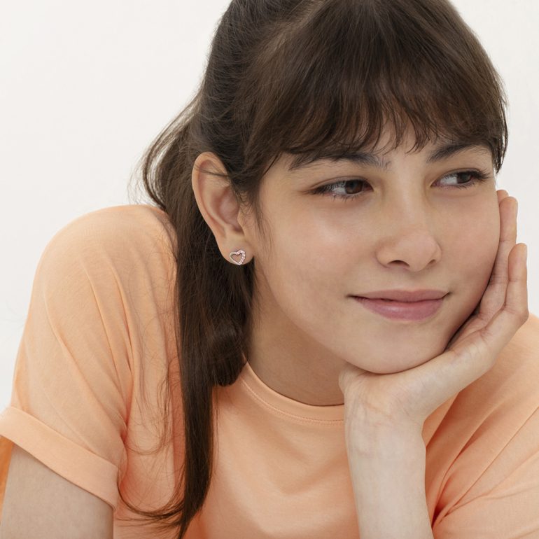 A pair of sterling silver stud earrings with pink cubic zirconia - hearts