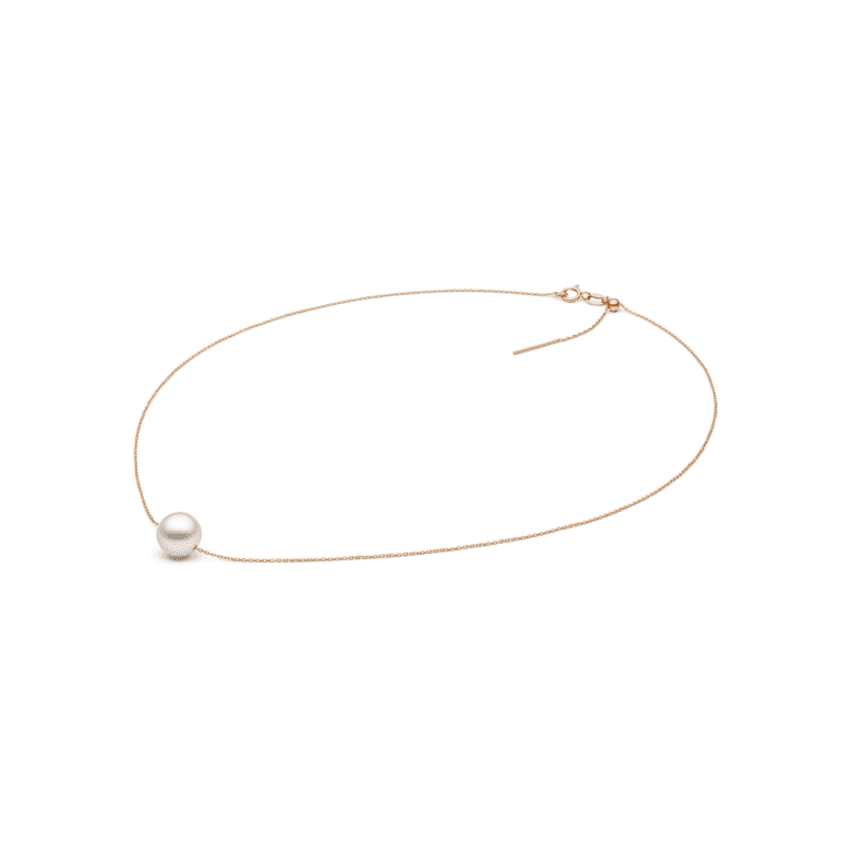 A minimalist rose gold necklace with white pearl