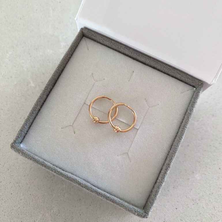 Rose gold hoop earrings with engraved golden beads
