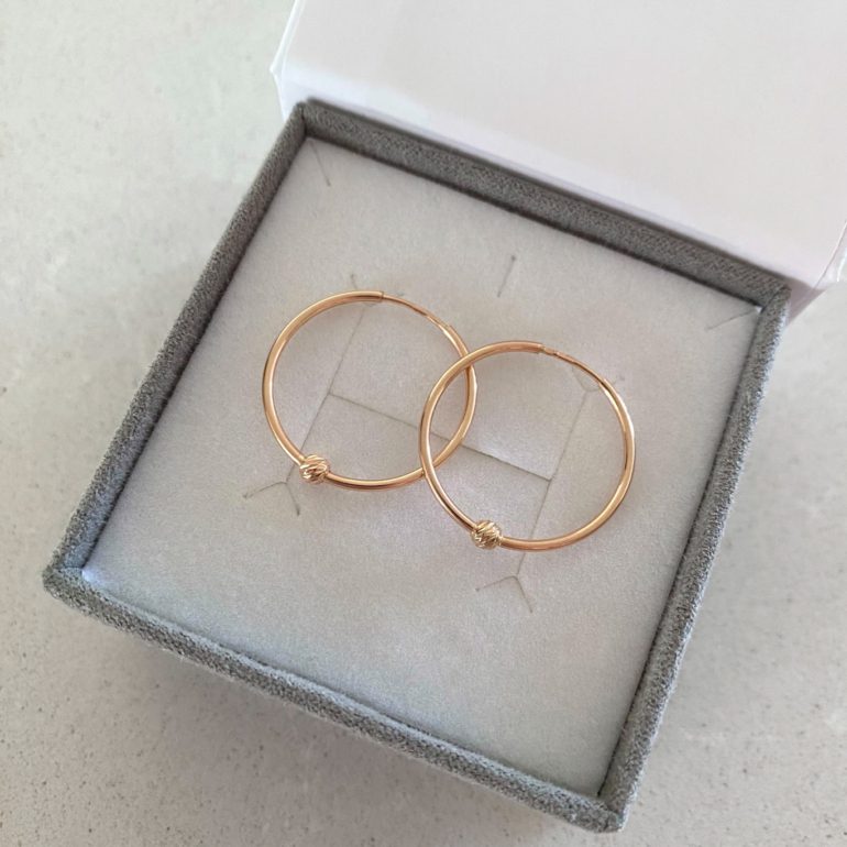 Rose gold hoop earrings with engraved golden beads