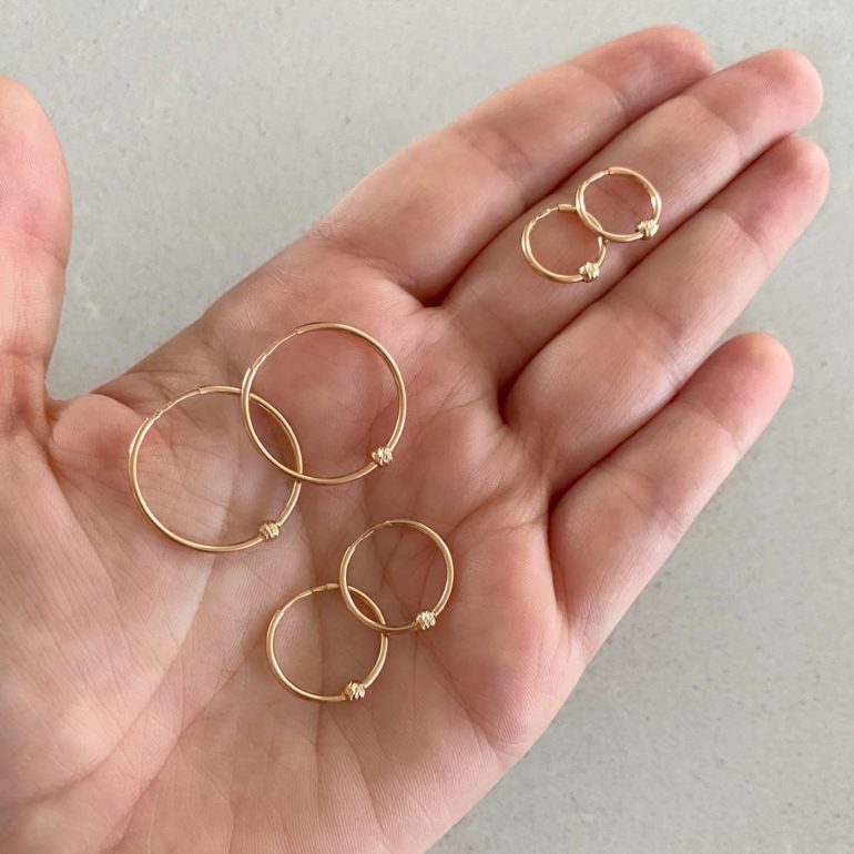Rose gold hoop earrings with engraved golden beads