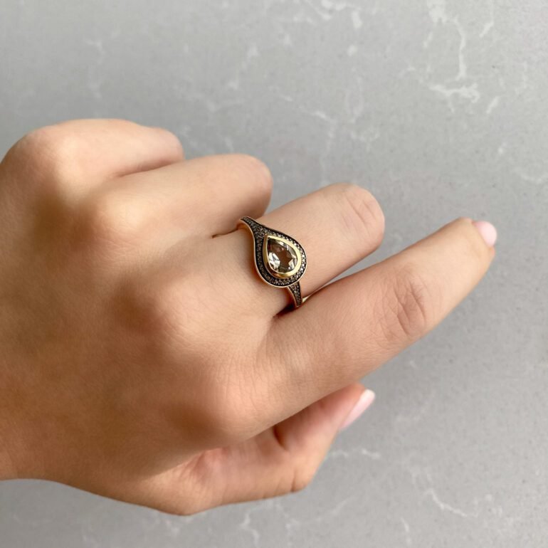 A luxurious rose gold ring with smoked quartz and diamonds