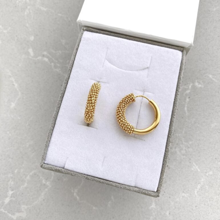 A modern yellow gold hoop earrings