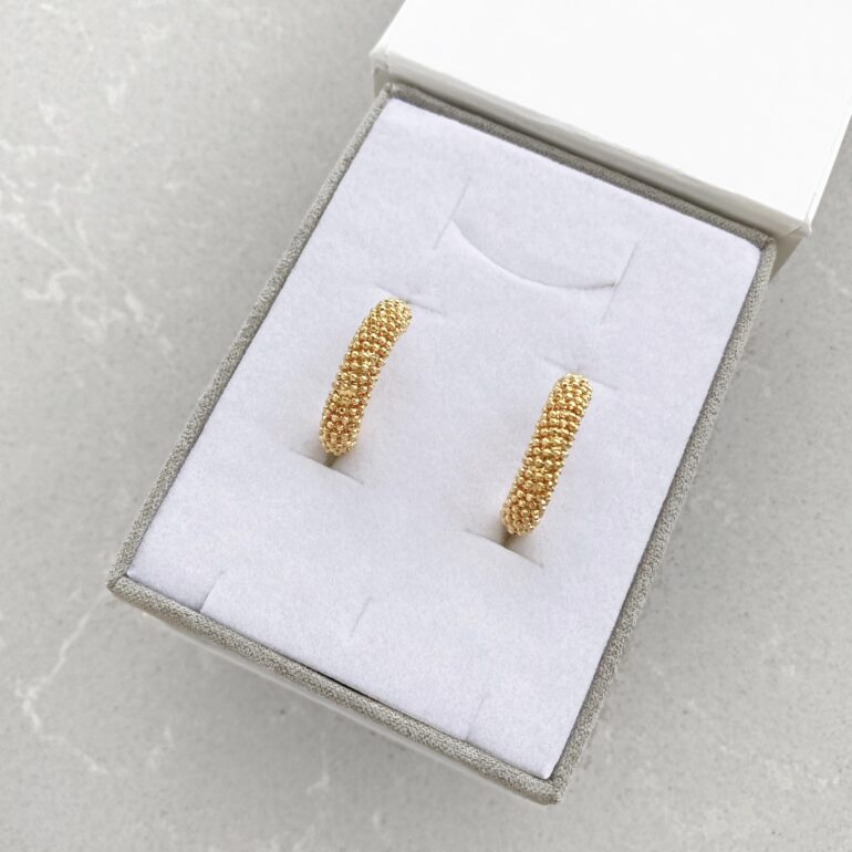 A modern yellow gold hoop earrings