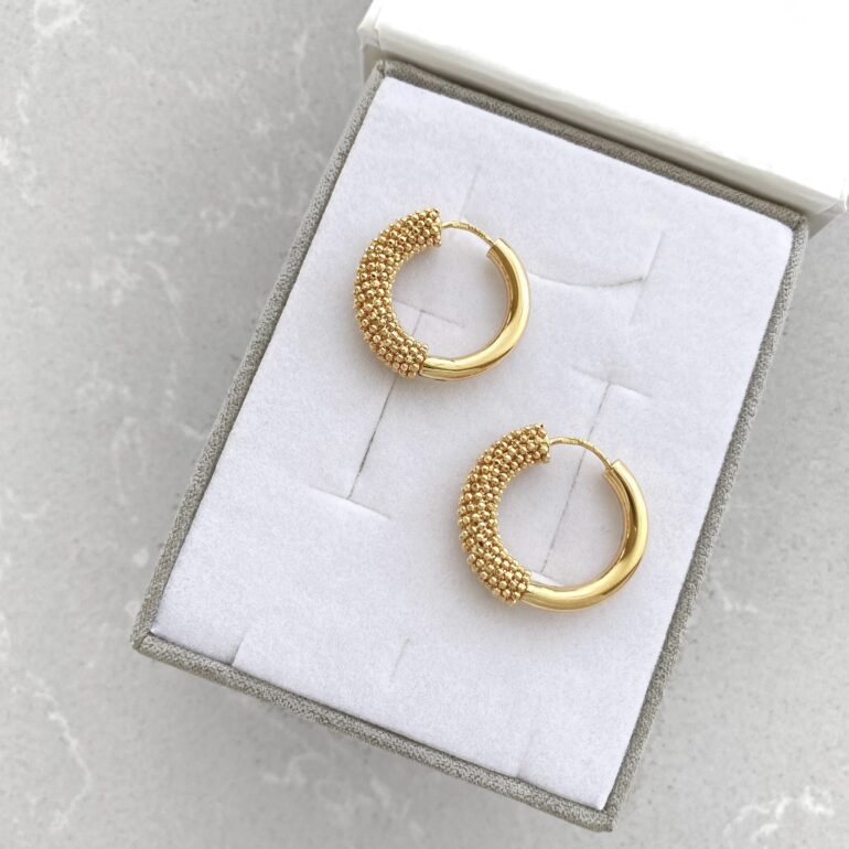 A modern yellow gold hoop earrings