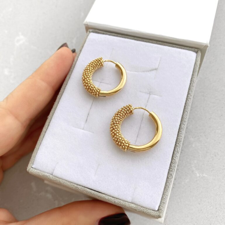 A modern yellow gold hoop earrings