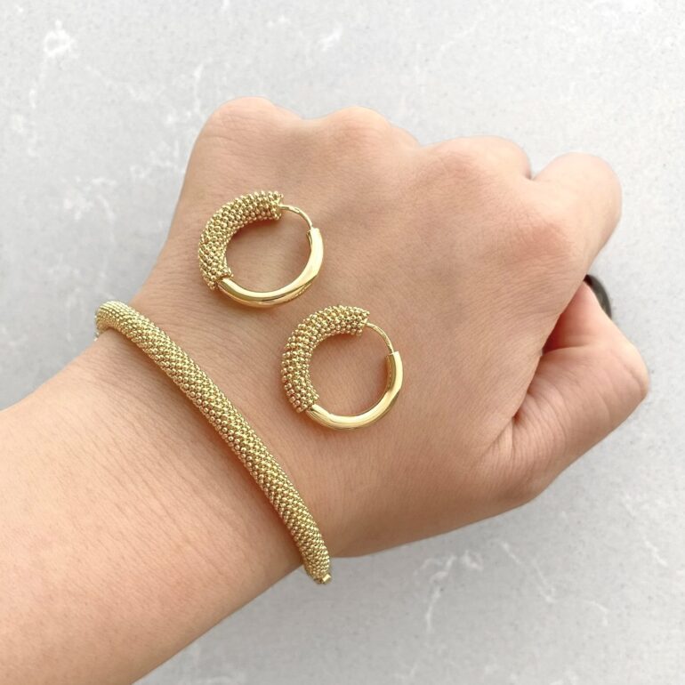 A modern yellow gold hoop earrings