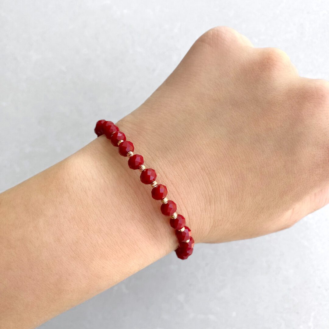 Red string bracelet with red beads and gold