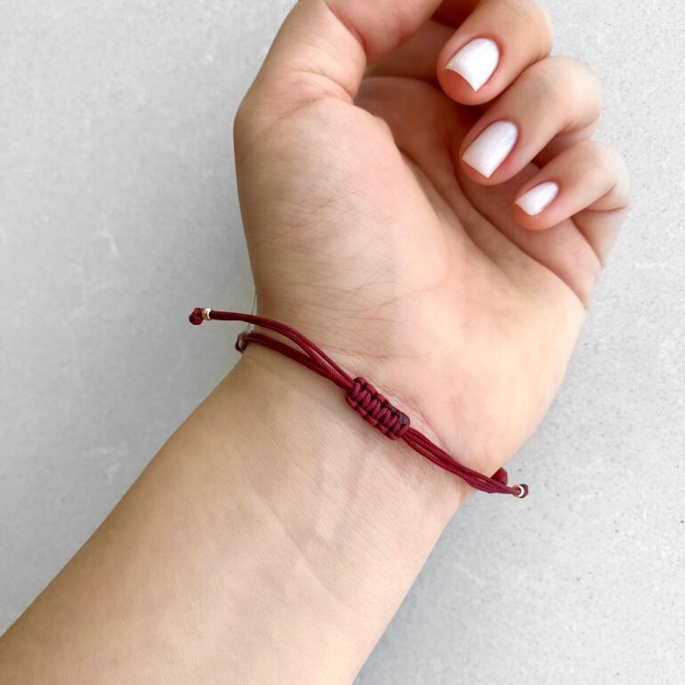 Red string bracelet with red beads and gold