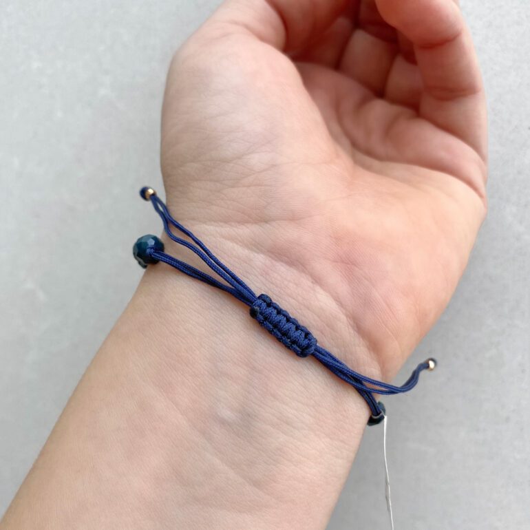 Blue string bracelet with beads and gold