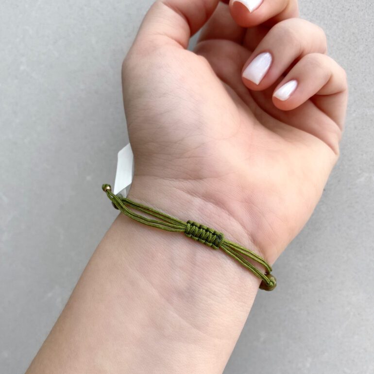 Green string bracelet with beads and gold