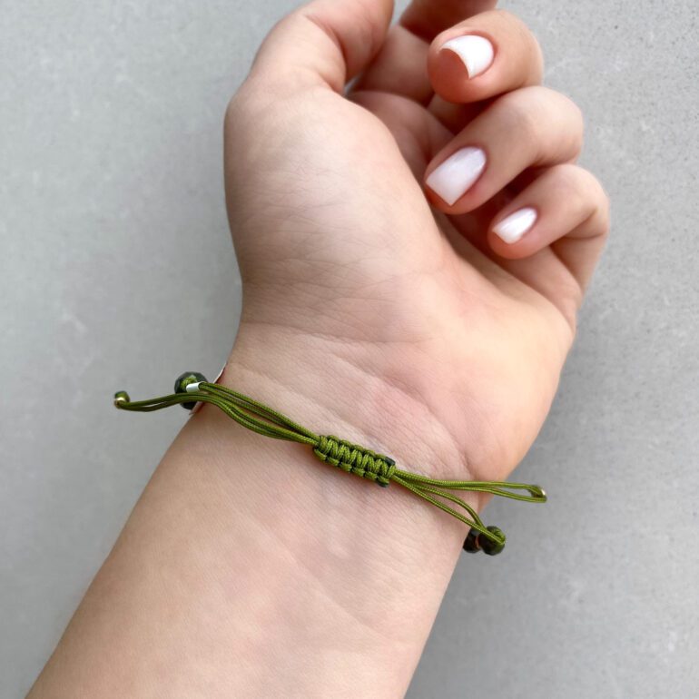 Green string bracelet with khaki beads and gold