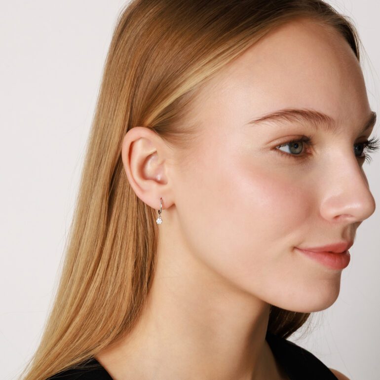 Sterling silver hoop earrings with dandling cubic zirconia