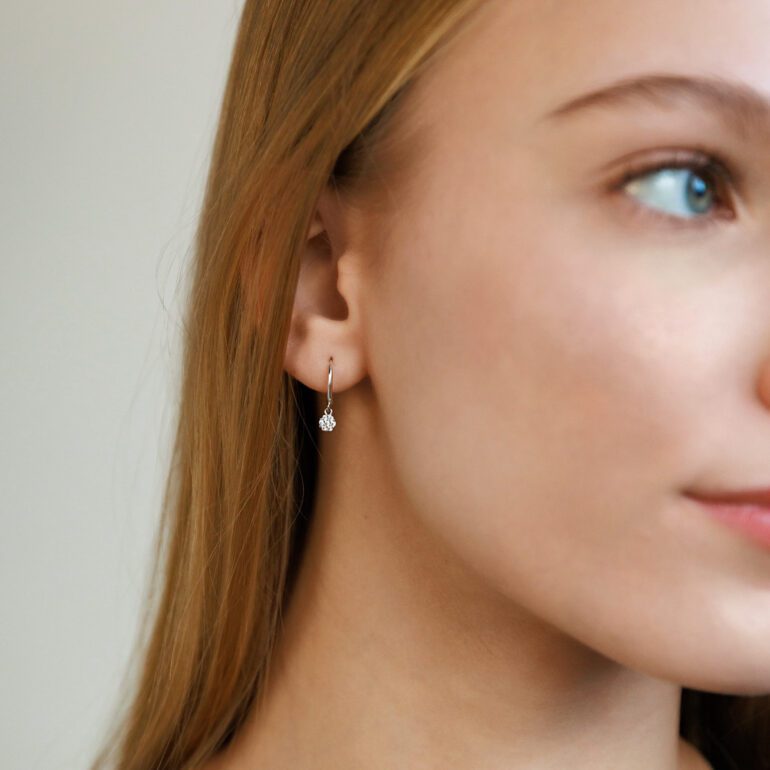 Sterling silver hoop earrings with dandling cubic zirconia